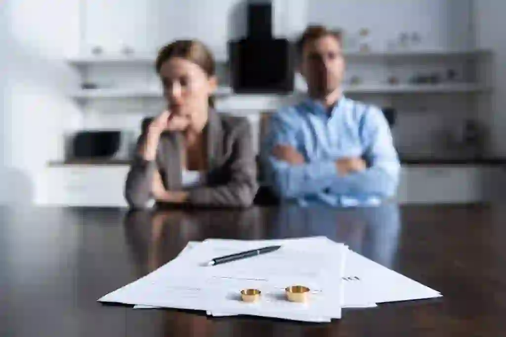 Couple divorcing with rings on table