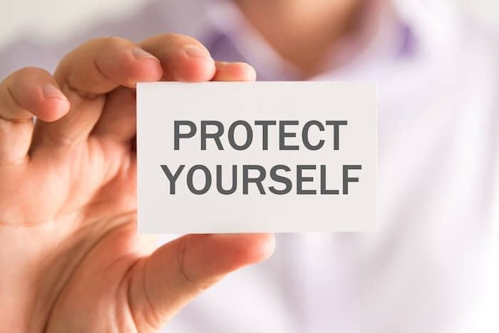 Businessman holding a card with PROTECT YOURSELF with probate